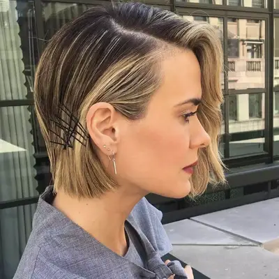Sarah Paulson wears her bob is a deep side part with scrambled bobby pins decorating one side