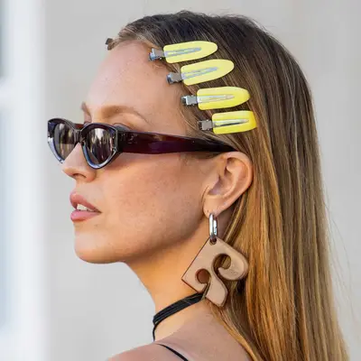 Zazie Beetz wears her natural texture shaped up and adorned with pearl bobby pins