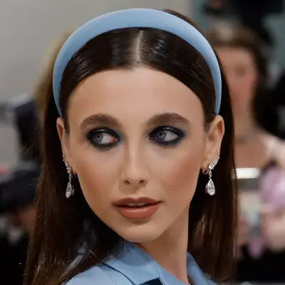 Emma Chamberlain wears a blue headband behind a clean center part to the Met Gala