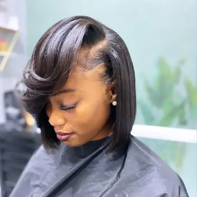 Person wears an asymmetrical bob with retro waves and volume