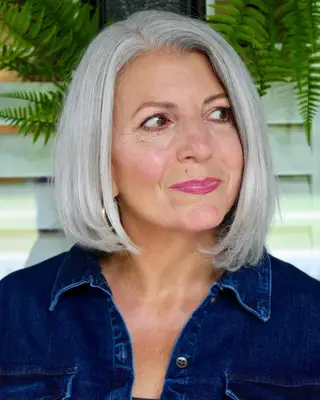 Person with subtle silver asymmetrical bob