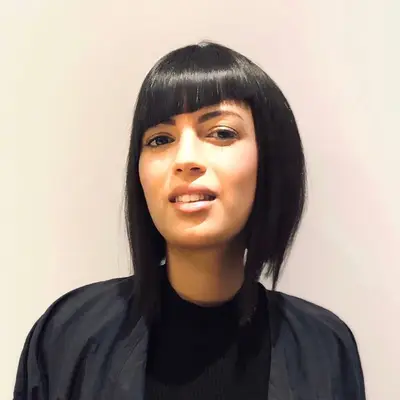 Person wears asymmetrical bob with bangs