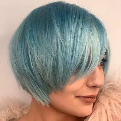 Person wears a shaggy blue asymmetrical bob