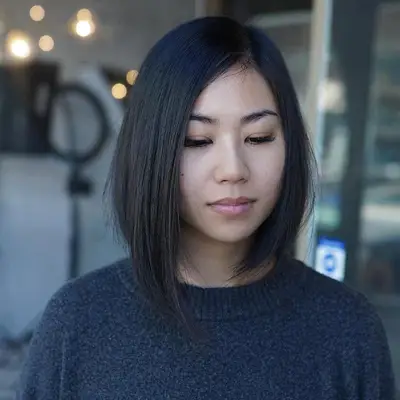 Person wears a soft asymmetrical bob