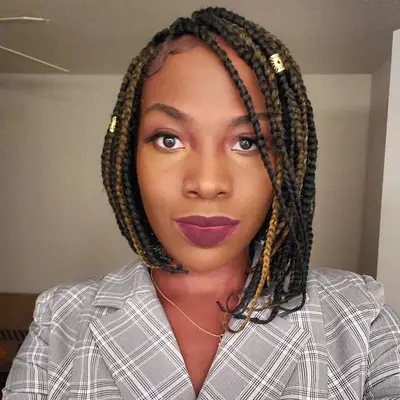 Person with asymmetrical bob braids