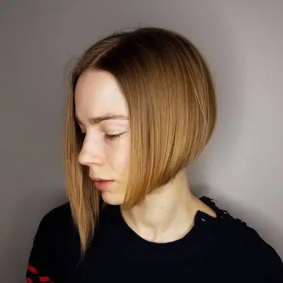 Person with a sleek, short asymmetrical bob