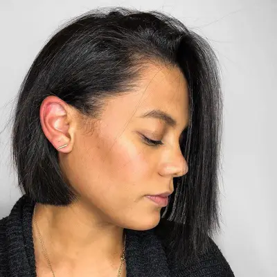 Person wears asymmetrical bob with lightweight layers