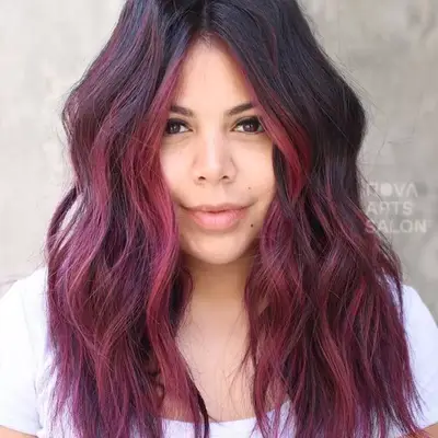 Woman wears cherry pink ombré hair with dark roots