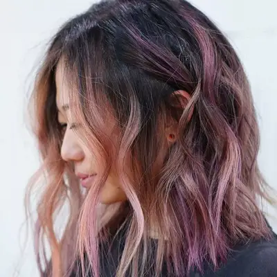 Woman wears a pink ombré lob