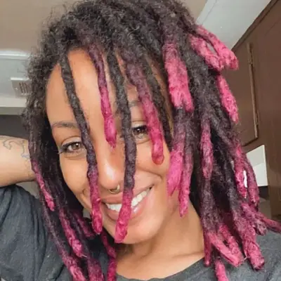 Woman with hot pink ombré dipped dreadlock hairstyle
