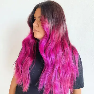 Woman with vivid fuchsia extra-long pink ombré hair
