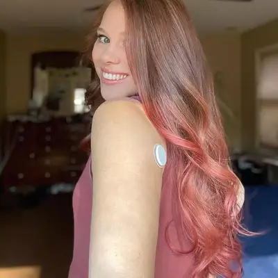 Woman with long pink ombré hair with sandy brown base