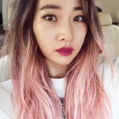 Woman with long light pink ombré hair