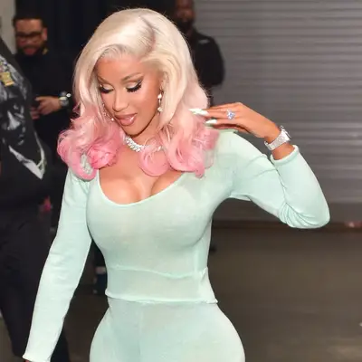 Cardi Bi with curly blonde and pink ombré hair