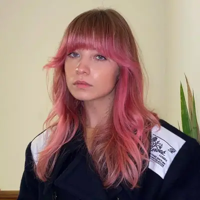 Woman wears pink ombré hair with flared 