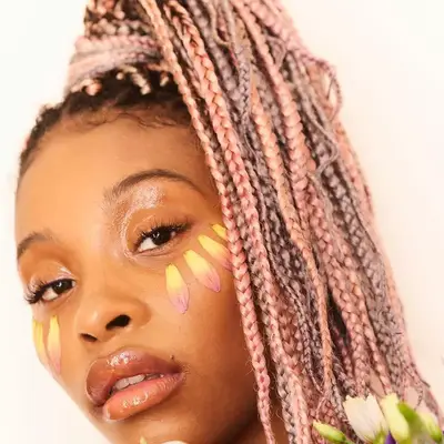 Woman wears pink ombré box braid ponytail
