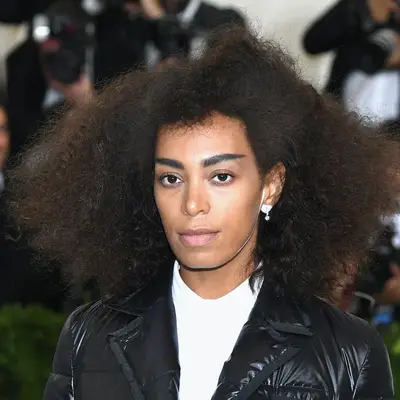Solange wearing a combed-out curly hairstyle with short bangs at the 2017 Met Gala in New York City