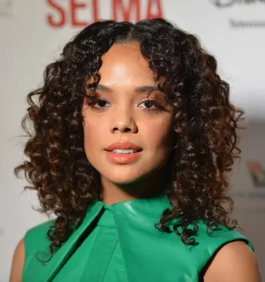 Tessa Thompson with a curly shoulder-length shag and face-framing bangs at the 2015 AAFCA Awards in Hollywood, California