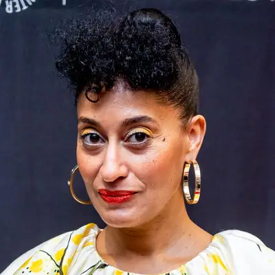Tracee Ellis Ross wearing a tight updo hairstyle with curly bangs at the 2019 PaleyFest event in New York City