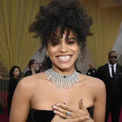 Zazie Beetz with long curly bangs and a high updo at the 2020 Academy Awards in Hollywood, California