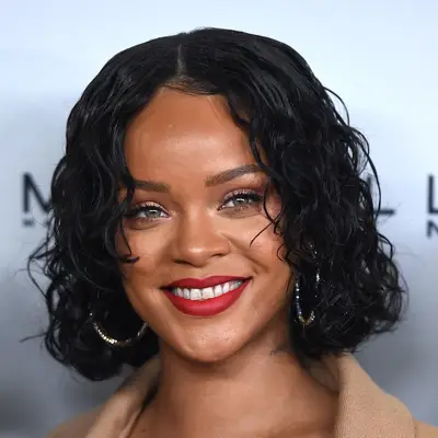 Rihanna wears a curly bob hairstyle with wispy face-framing bangs at the 2017 Parsons Benefit in New York City