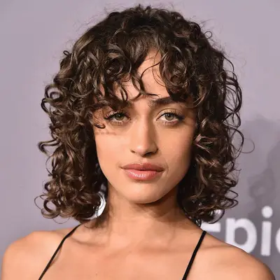 Alanna Arrington wears a curly bob hairstyle with bangs at the 2018 amfAR Gala in New York City