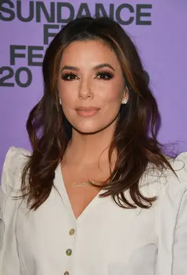 Close up of Eva Longoria with long wavy layered hair