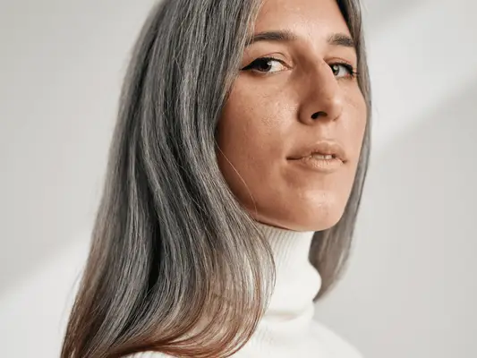 Close up of a woman with grey hair. 