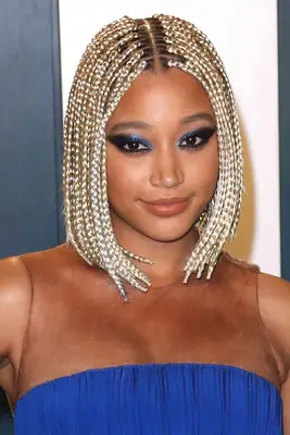 Amandla Stenberg wearing platinum blonde box braids in a bob style