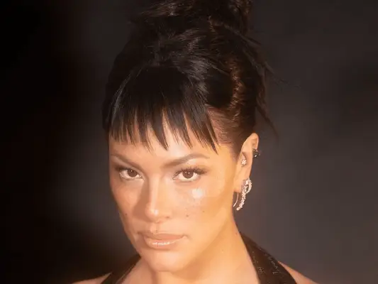 ashley graham wearing bun with baby spiky bangs