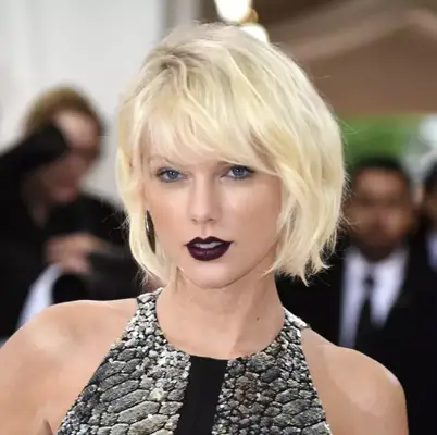 Taylor Swift with platinum blonde hair. 