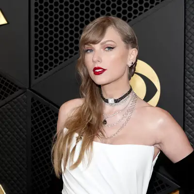 Taylor Swift with a side part braid. 