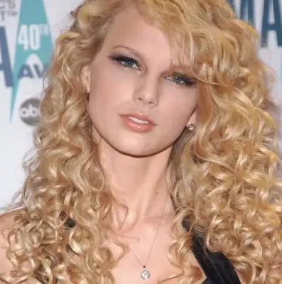 Taylor Swift with curly hair. 