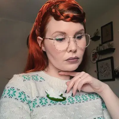 Woman wears a red braided crown hairstyle