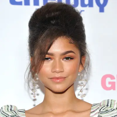 Zendaya wears a modern beehive updo hairstyle with face-framing side bangs
