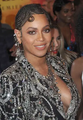Beyonce Knowles-Carter with swirled braided hairstyle like josephine baker