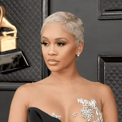 Saweetie wearing ash blonde pixie
