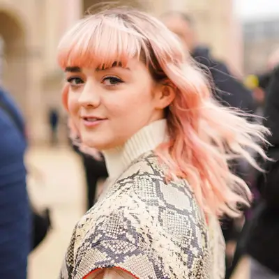 Maisie Williams in snakeskin print outfit and muted Rose Gold Hair