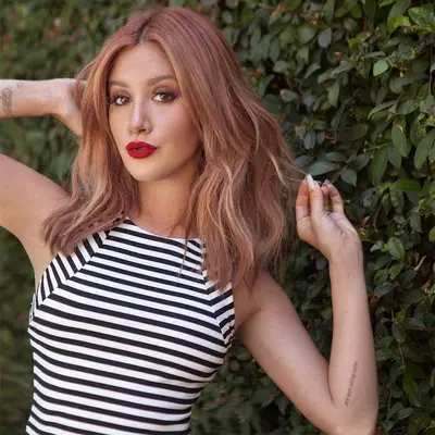 Ashley Tisdale in black and white striped tank and red lips with bronde pink Rose Gold Hair