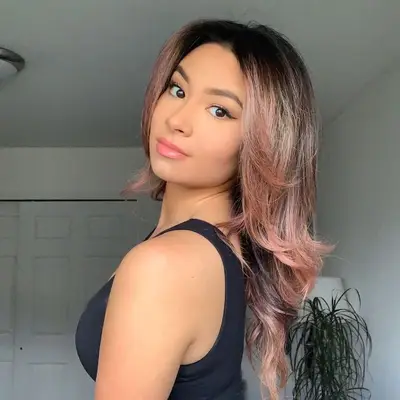 brunette woman in black tank top with subtle rose gold tips