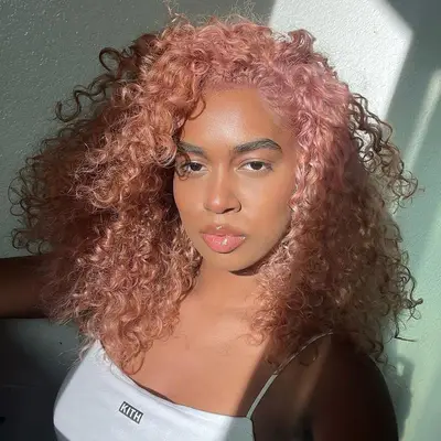 Model with pastel peach curly natural hair