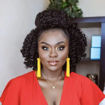 woman in red shirt with curly hair