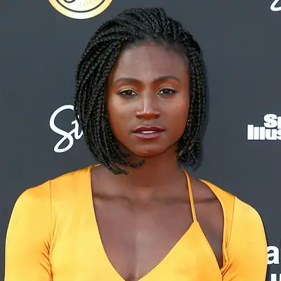 Tori Bowie wears a box braided bob hairstyle and warm eye makeup