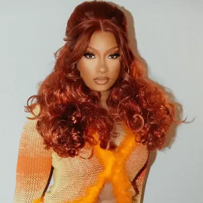 Megan Thee Stallion with platinum curls and cotton-candy pink lowlights