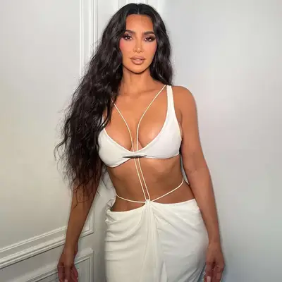 Kim Kardashian in a white dress with mermaid waves hair
