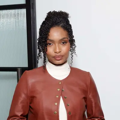 Actor Yara Shahidi with her curly hair in a messy bun