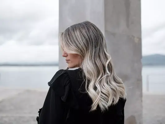 A woman with cool-toned blonde hair