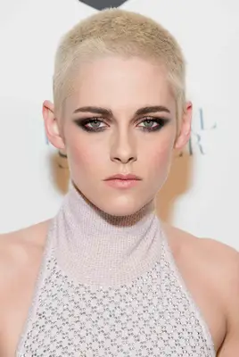 Kristen Stewart with a grown-out platinum buzz cut on the red carpet