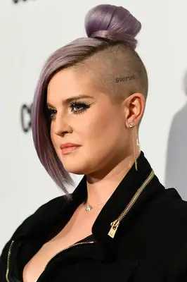Kelly Osbourne with a lilac clipper cut and a high bun on the red carpet