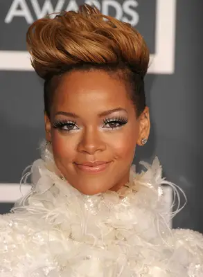 Rihanna with a shaven, messy pompadour hairstyle on the red carpet
